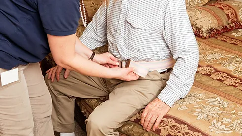 nurse helping elder patient stand with belt assist